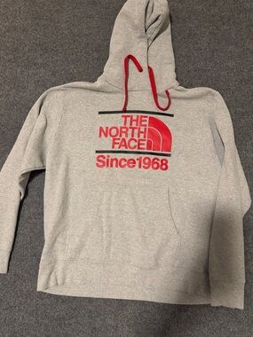 The North Face Men’s Gray Crewneck Hoodie with Red Logo and Red Drawcords